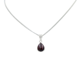 Delicate small teardrop cabochon gemstone pendant set in a thin bezel setting